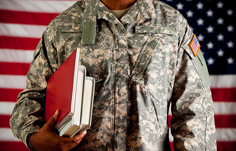 military student in front of flag